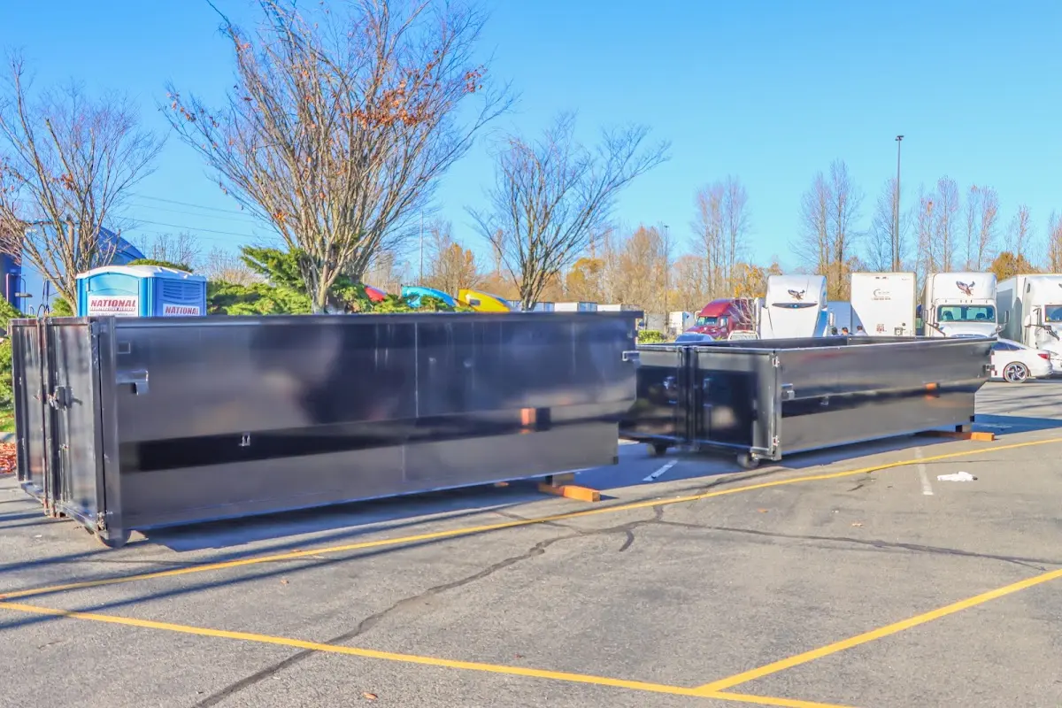 Professional dumpster rental service with roll-off container on residential driveway in Moorefield